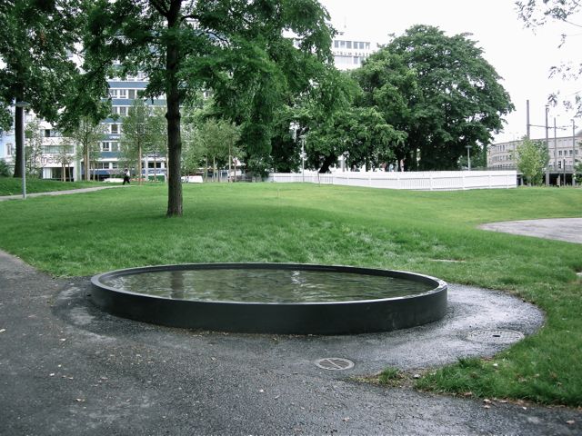 Fountain with relief in concrete, 2008. In the background the Installation 'Landler/Polka, Erich Steinbrecher. Basel, Elisabethenpark